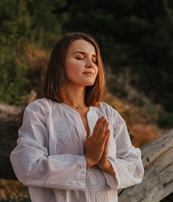 Woman in a calm yoga pose, surrounded by a feeling of peace and balance.